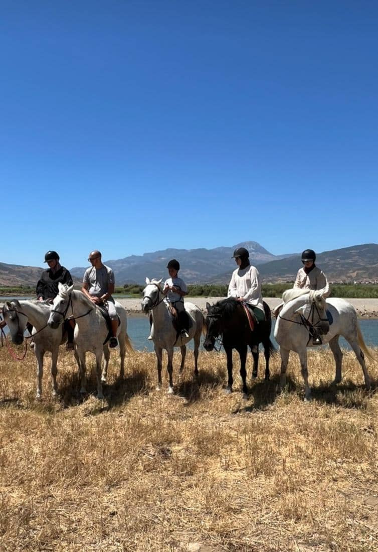 Cavaliers le long de l'oued Laou et de ses lagunes, entre les roseaux et les montagnes